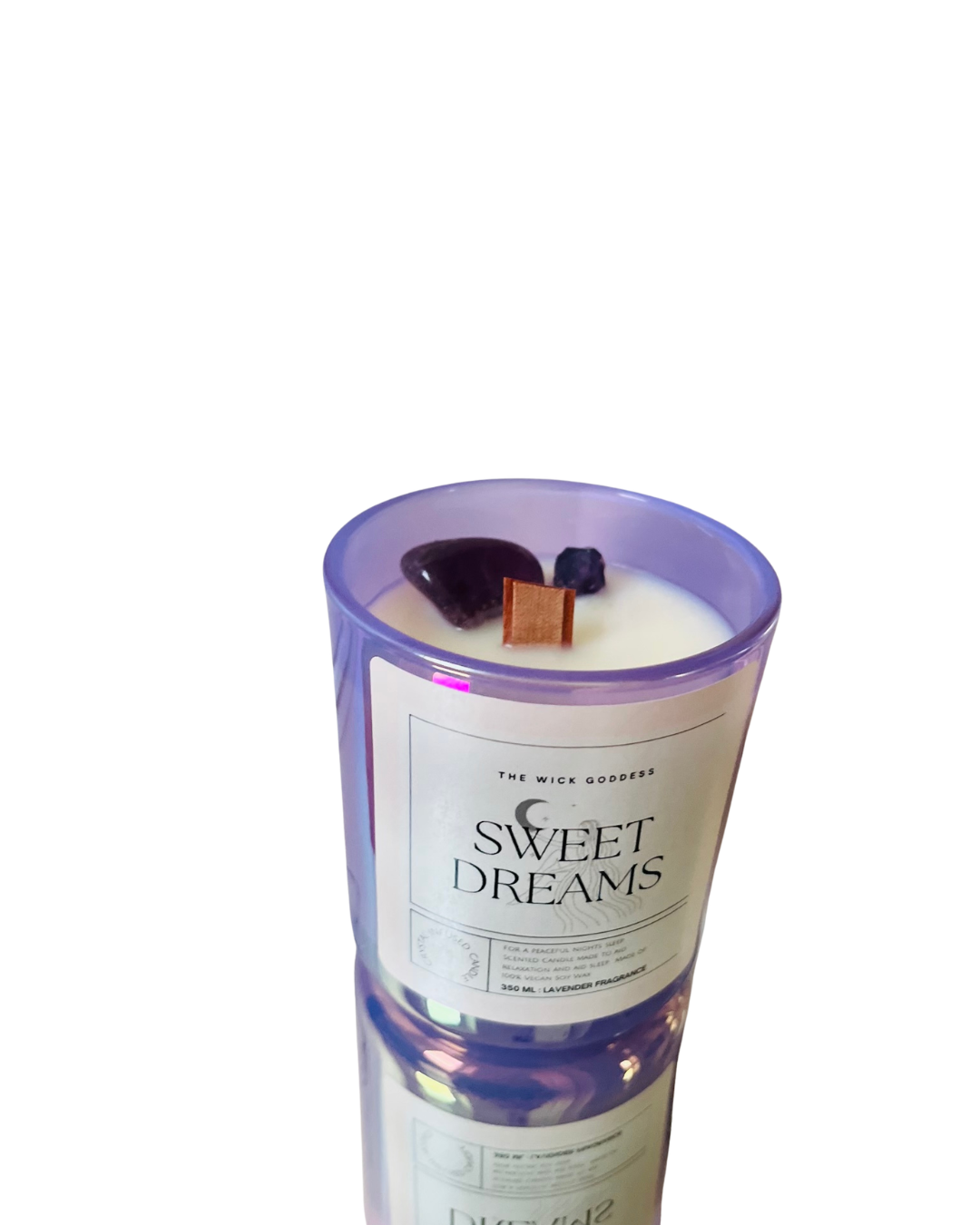 Candle with a label reading 'Sweet Dreams' on a white background