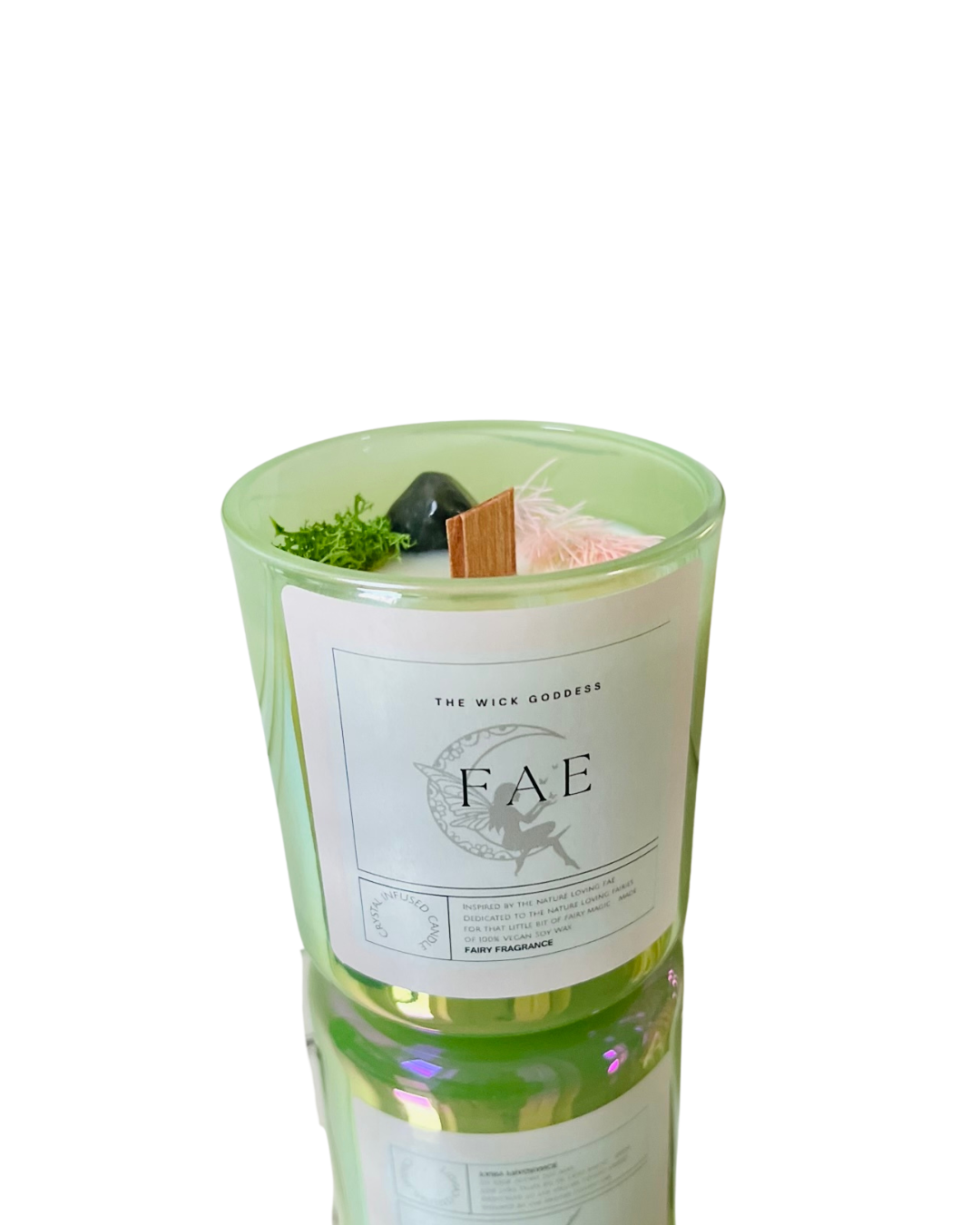 Candle with decorative elements and 'FAE' label on a white background