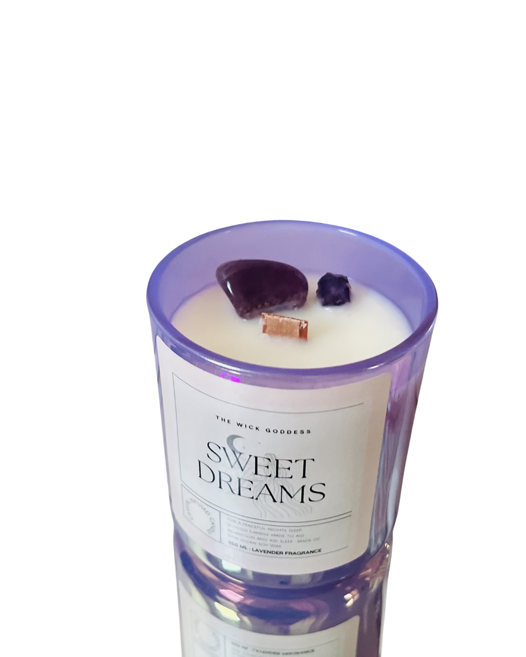Candle with 'Sweet Dreams' label in a purple container on a white background