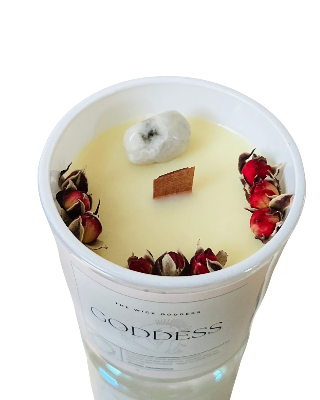 Candle with decorative elements in a container labeled 'Goddess' on a white background