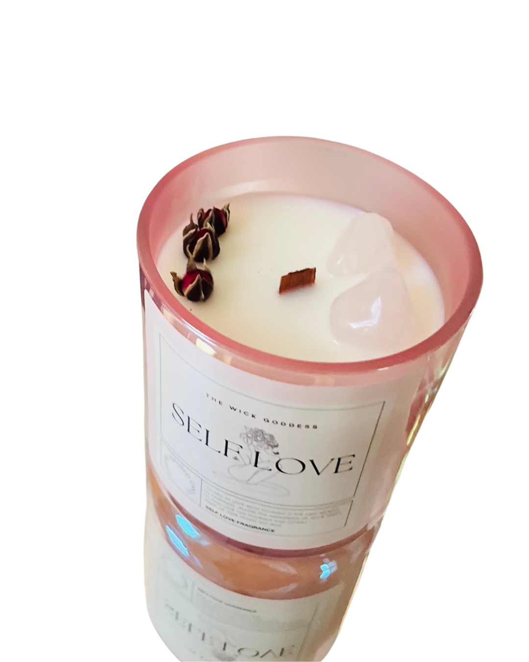 Candle in a glass container with a label on a white background